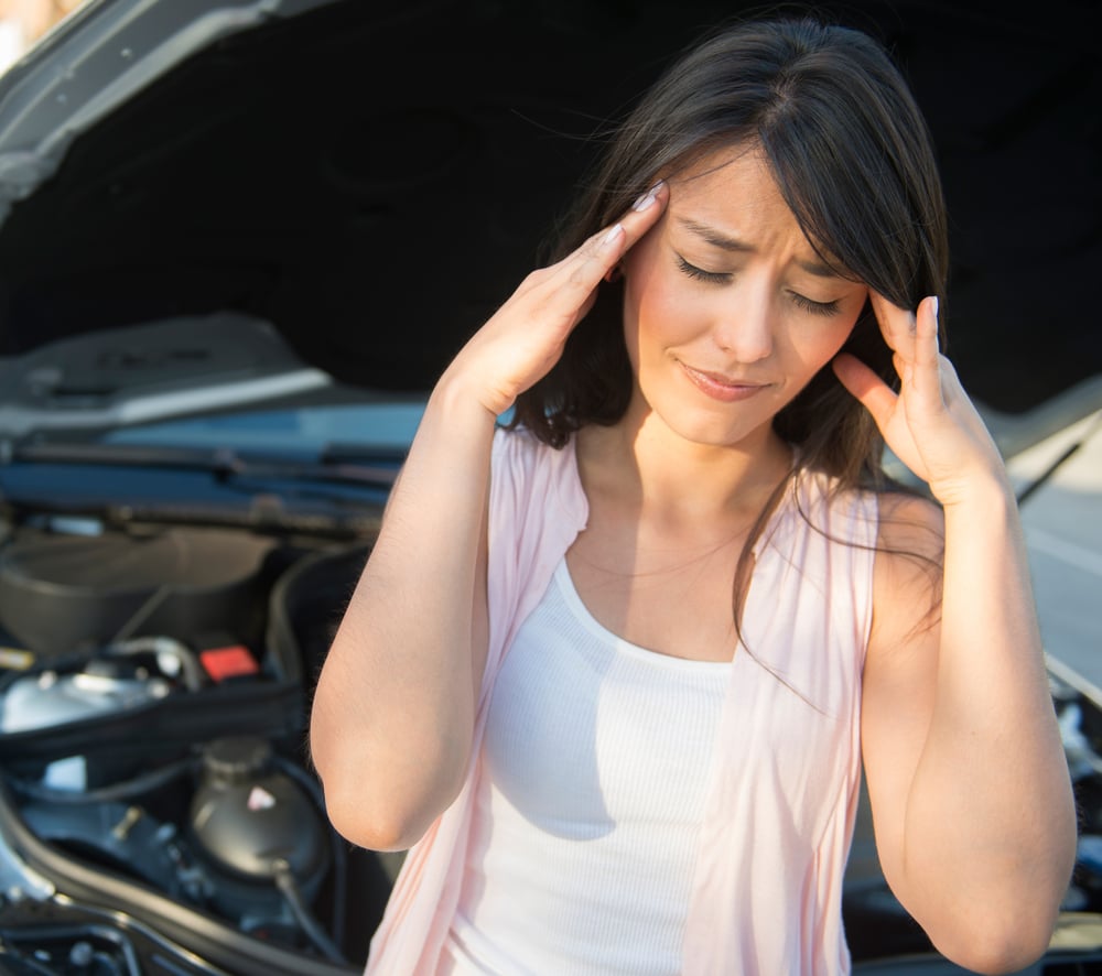 Frustrated woman having problems with her car