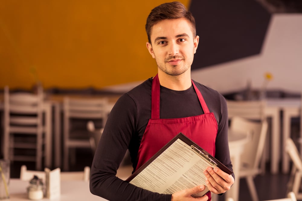 Photo of waiter during work in cafe