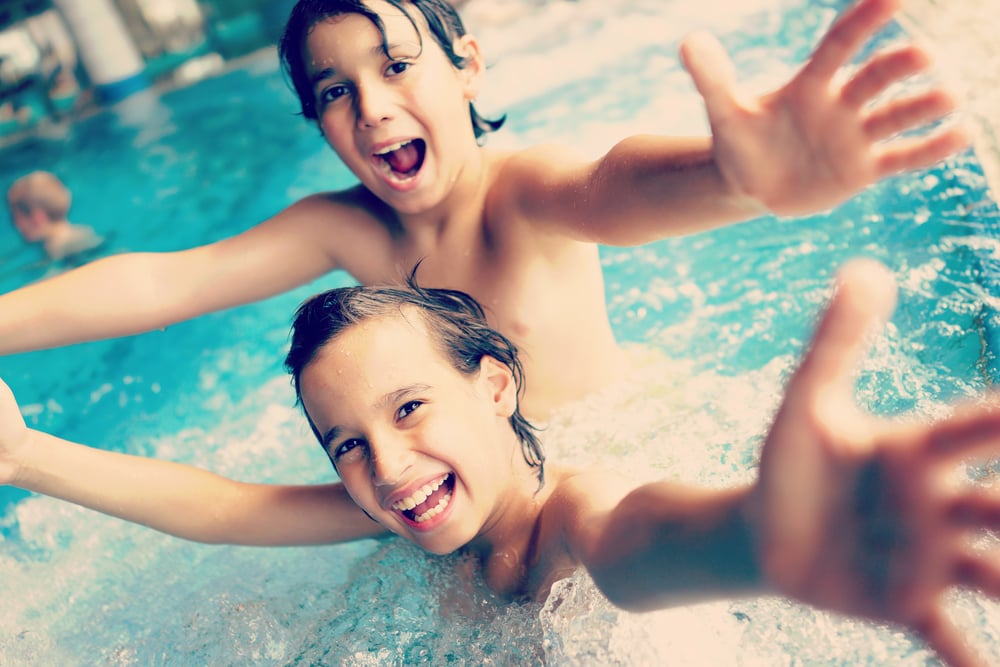 Two happy kids having fun on summer pool (colorized effect)